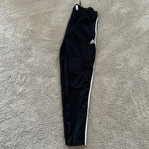 Black and white striped Adidas joggers.